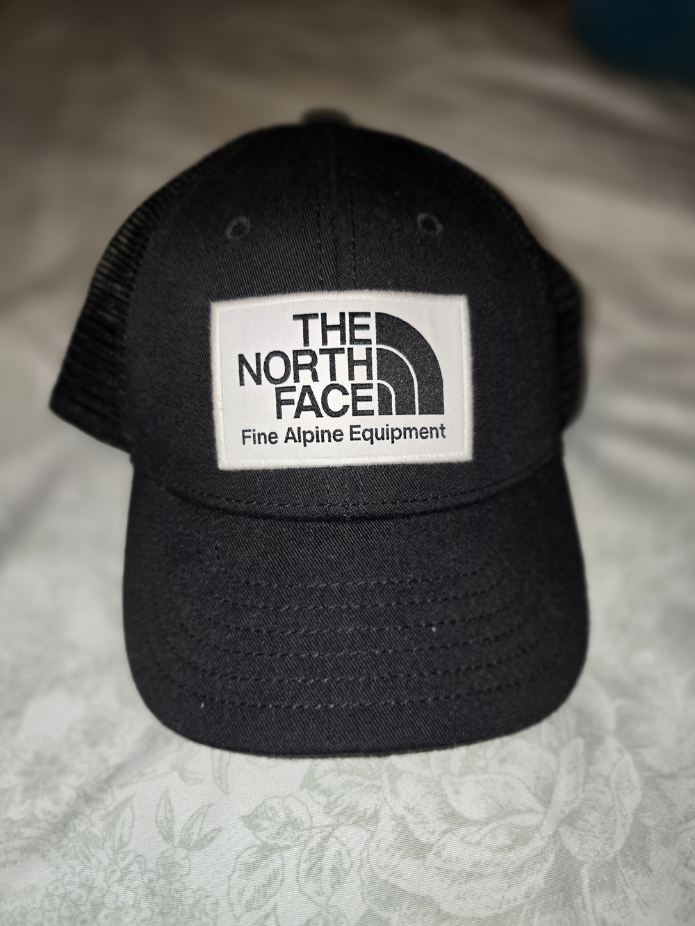 The North Face Black Cap with White Logo Patch
